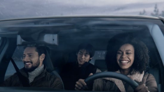 Three passengers riding in a vehicle and smiling | Ed Martin Nissan of Fishers in Fishers IN